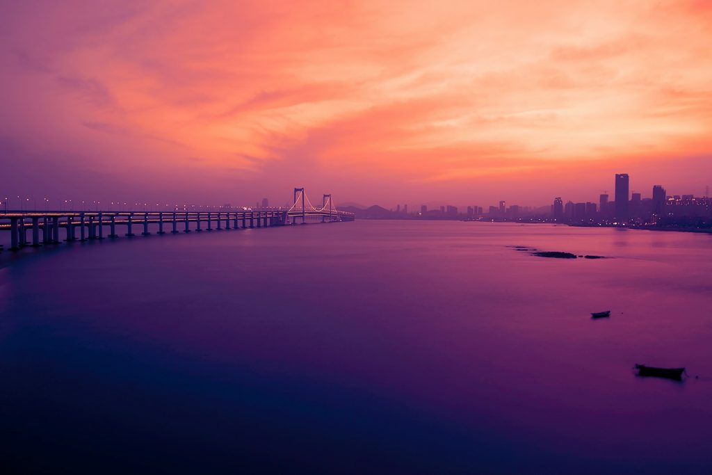 gray bridge above body of water during golden hour photography